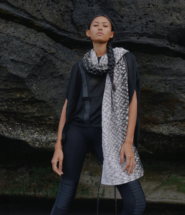 women standing in front of a black rock wearing a black and white tie dye linen scarf