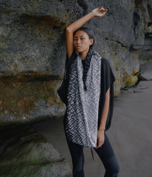 women standing in front of a rock wearing a black and white tie dye linen infinity scarf