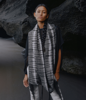 women standing in front of a black rock wearing a black and white tie dye linen infinity scarf