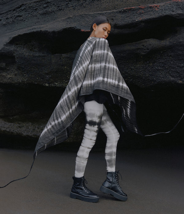 women standing in front of a black rock wearing a black and white tie dye linen scarf