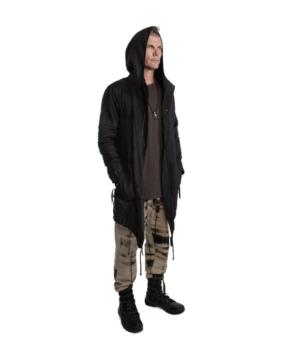  light weight linen parka. Featuring large lined hood, hidden snaps over front zip fastening, long sleeves with ribbed detail, Unisex parka made of light weight linen. Featuring large lined hood, hidden snaps over front zip fastening, long sleeves with ribbed detail, snaps on cuffs, a drawstring waist, front frayed edge pockets, leather detail on cuffs, collar and back, leather tassel zip on outside chest pocket, earphone loop on inside chest pocket, a drawstring hem and a mid-length.