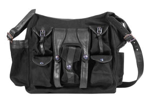 Canvas and leather shoulder travel bag with fabric lining and custom hardware.