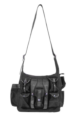 Canvas and leather shoulder travel bag with fabric lining and custom hardware.