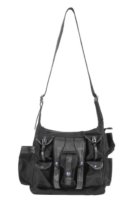 Canvas and leather shoulder travel bag with fabric lining and custom hardware.
