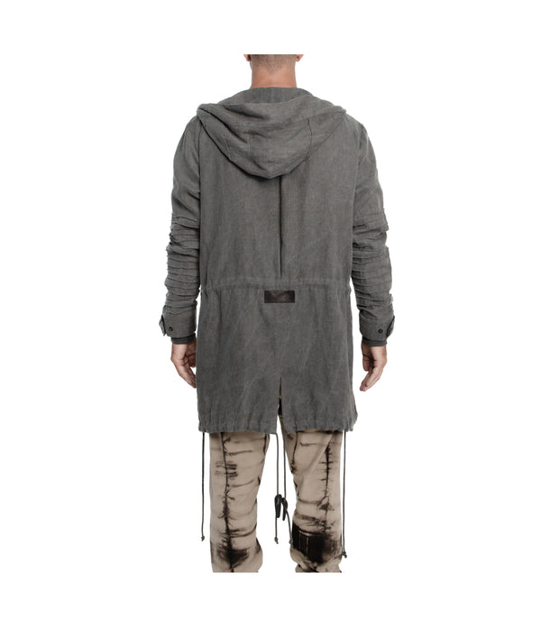 Unisex 100% linen parka. Made of light weight linen. Featuring large lined hood, hidden snaps over front zip fastening, long sleeves with ribbed detail, snaps on cuffs, a drawstring waist, front frayed edge pockets, leather detail on cuffs, collar and back, leather tassel zip on outside chest pocket, earphone loop on inside chest pocket, and adrawstring hem.