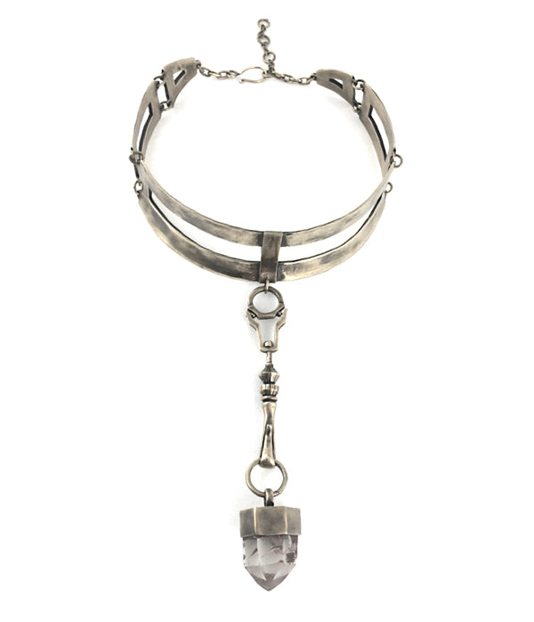 Choker with quartz crystal pendant.